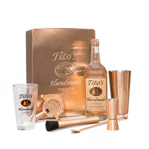 Tito's Vodka copper gift box with copper-plated shaker, strainer, muddler, spoon, jigger, and pint glass