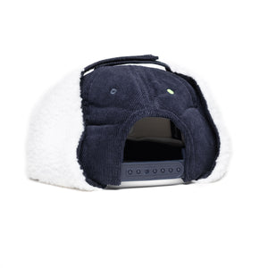 Back of navy snapback with fuzzy ear flaps