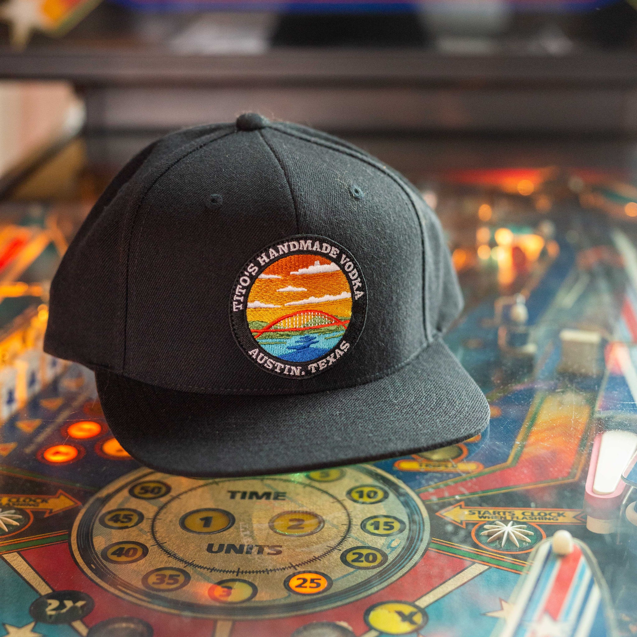 Tito's Hometown Hat sitting on an arcade game