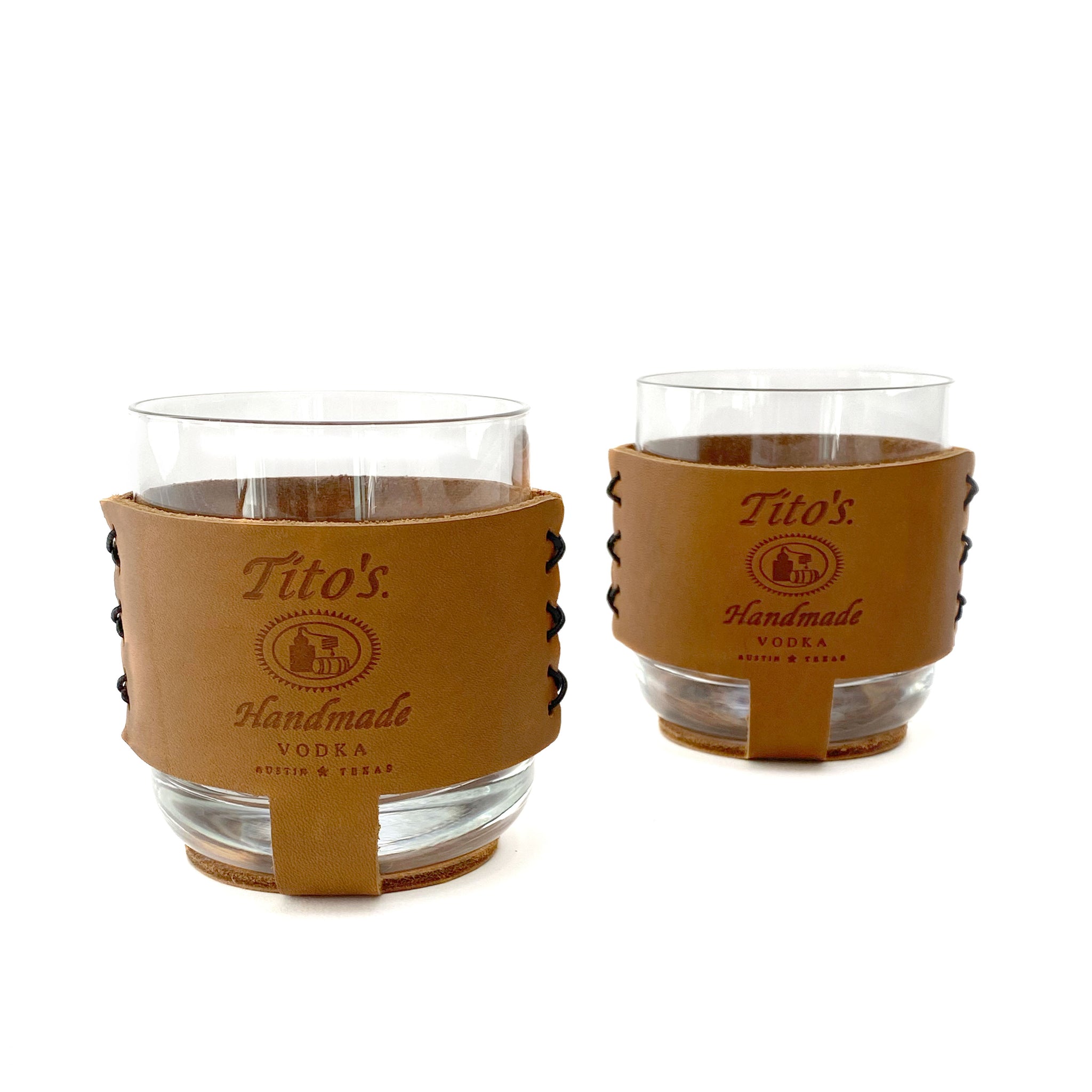 Packaged set of rocks cocktail glasses in leather sleeves branded with Tito’s Handmade Vodka logo