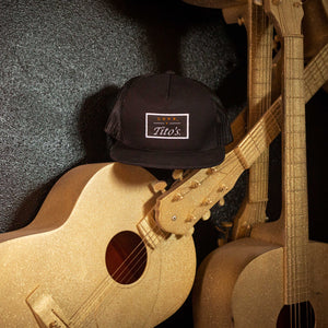 Love, Tito's Patch hat placed on a guitar