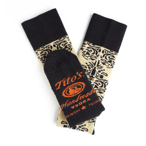 Black/sand colored half-calf socks with Tito's Handmade Vodka logo on bottom