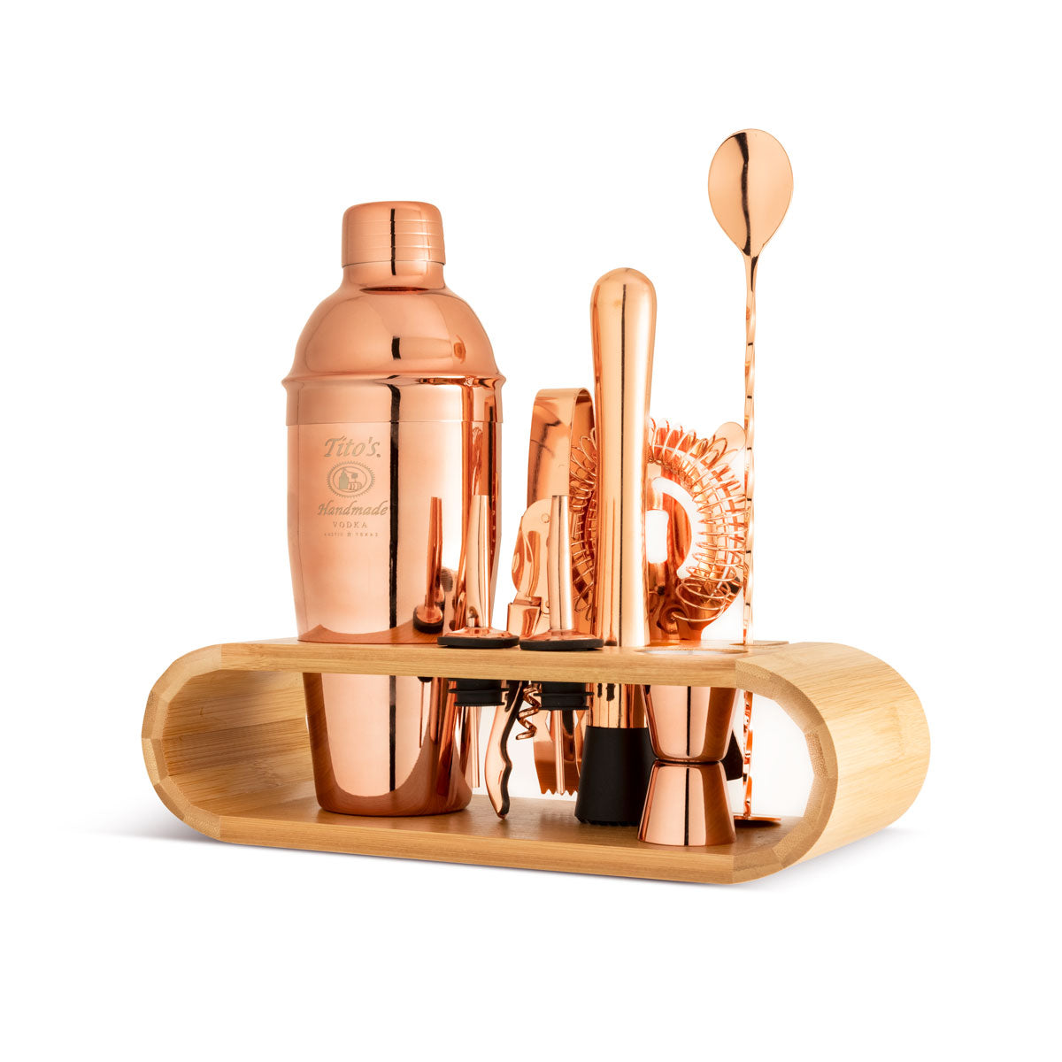 Tito's Stand Up Copper Cocktail Set with stainless steel shaker, jigger, tongs, strainer, two pour spouts, muddler, mixing spoon and stirrer, strainer, corkscrew and  bottle opener, with a beechwood stand