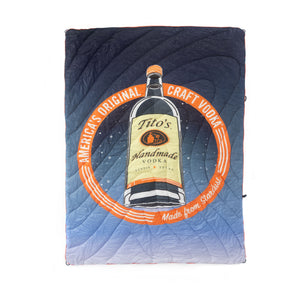 Blue fade blanket with Tito's Handmade Vodka bottle, stardust design and orange ring with America’s Original Craft Vodka Established 1997