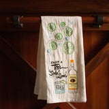 White tea towel with printed Enjoy a Tito’s Soda & Lime design and embroidered limes