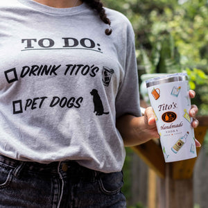 Girl wearing Tito's To-Do List Tee and holding a Tito's Tumbler with a Twist