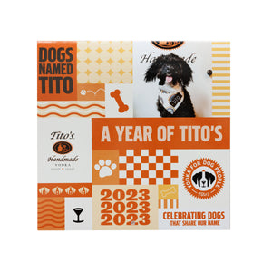 Front of orange and white desk calendar with dog designs, Tito's Handmade Vodka logo, and Vodka for Dog People logo