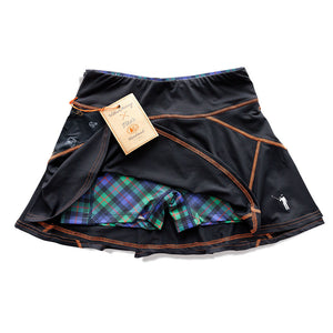 Underside of black skort with blue, green, and red plaid shorts