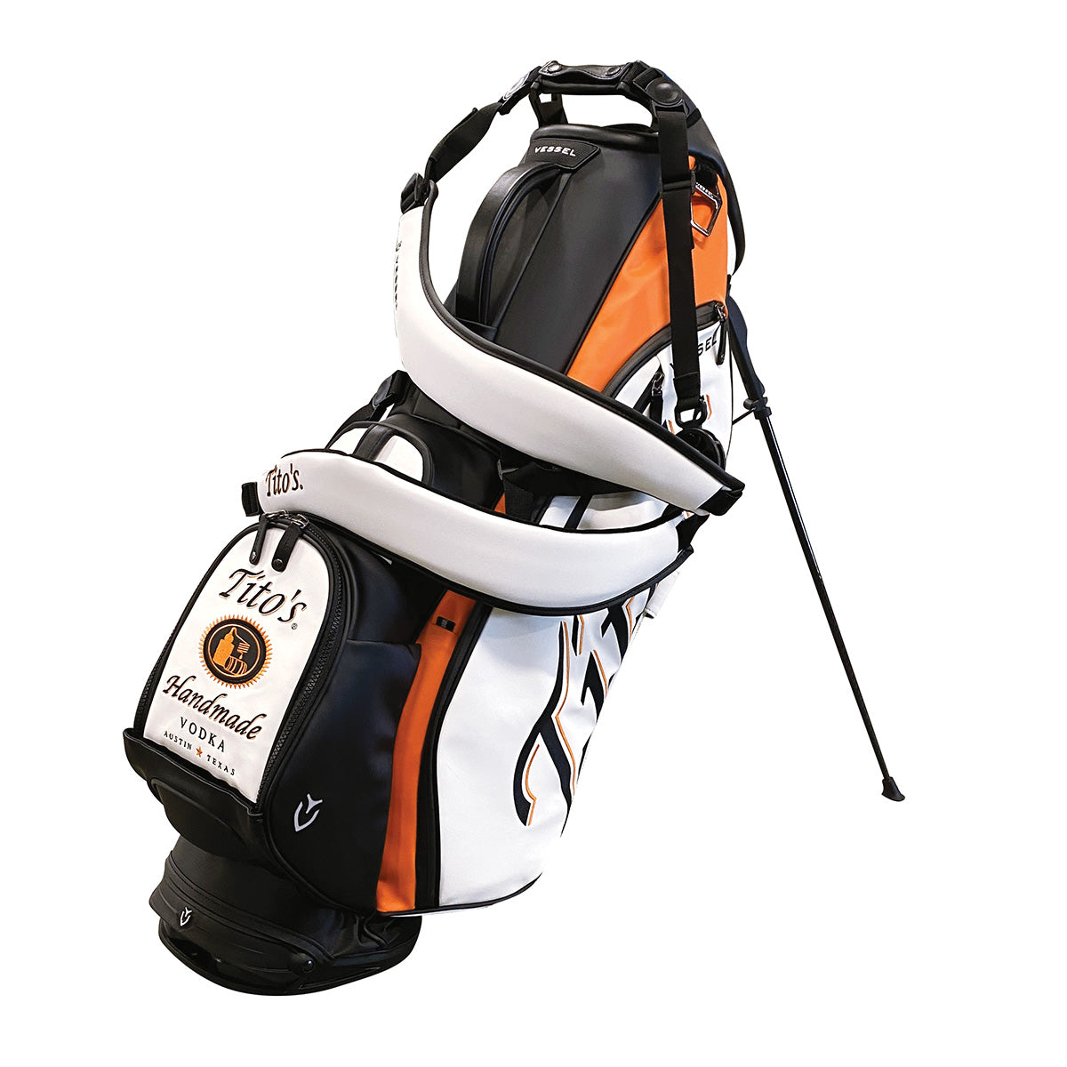 Back of white, black, and orange VESSEL golf bag with Tito's Handmade Vodka logo and wordmarks
