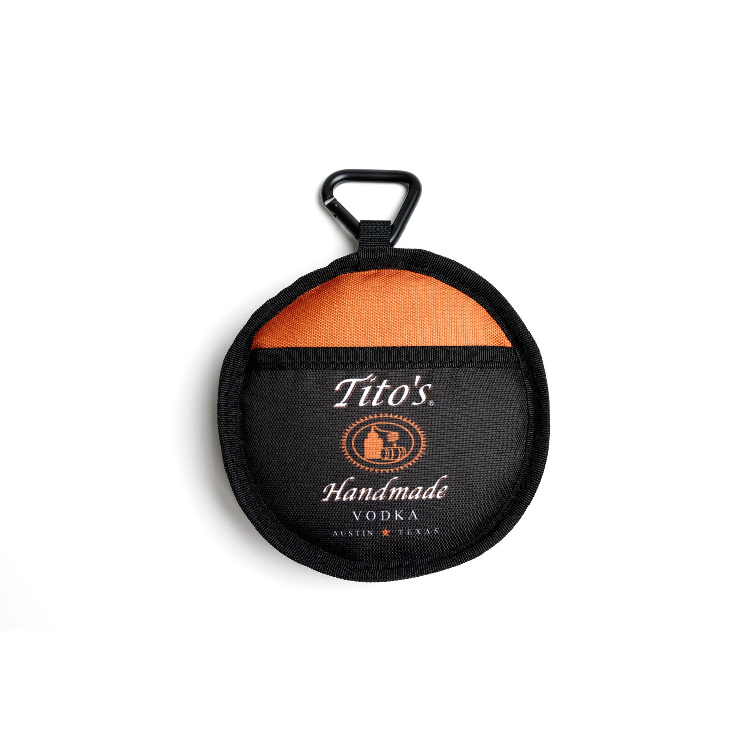 Closed view of black, orange, and white collapsible dog bowl with Tito's Handmade Vodka logo and dog leash carabiner