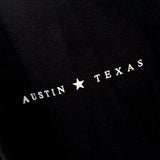 Black long sleeve with Austin, Texas text on sleeve