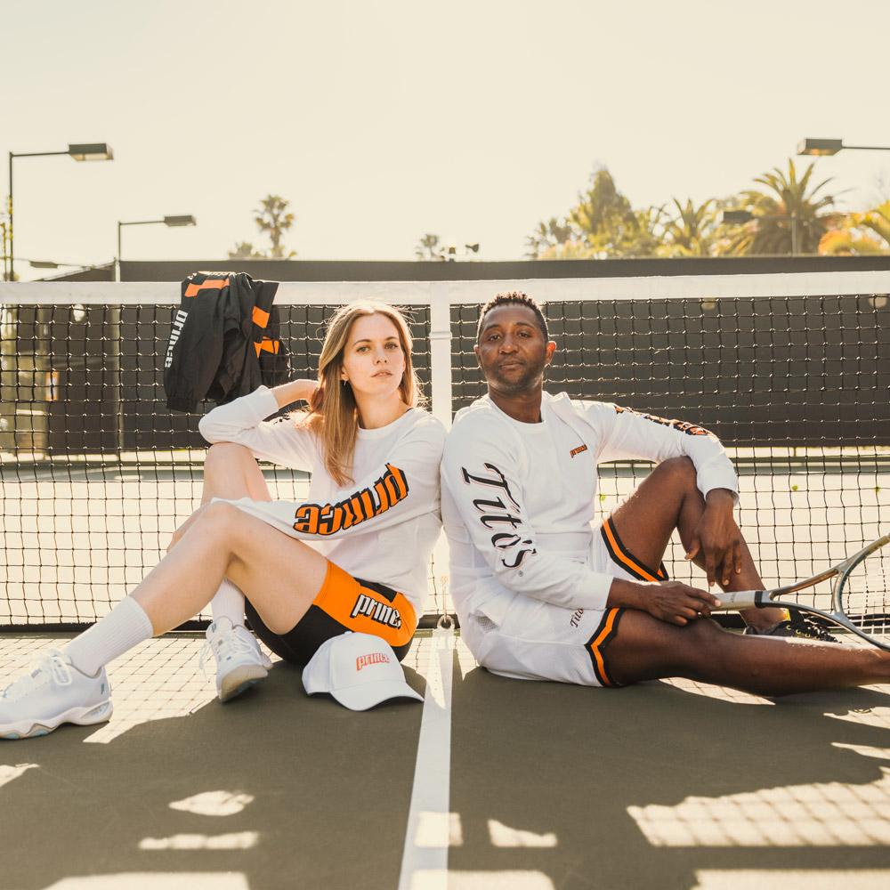 Man and woman on tennis court wearing white long sleeve